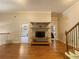 Open living room with hardwood floors, shelf, tv and entrances to other rooms at 311 Carmichael Cir, Canton, GA 30115