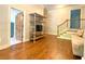 Open living room featuring hardwood floors, shelf with television and staircase to the second story at 311 Carmichael Cir, Canton, GA 30115