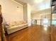 Bright living room featuring hardwood floors, high ceilings, sofa, and metal staircase at 311 Carmichael Cir, Canton, GA 30115