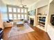 Bright living room with hardwood floors, large windows, built-in shelving, and a cozy fireplace at 311 Carmichael Cir, Canton, GA 30115