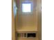 Mudroom with built-in bench, coat hooks and storage space below the bench at 311 Carmichael Cir, Canton, GA 30115