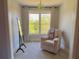 Bright sitting area with chair, large window with a nature view, and full-length mirror at 311 Carmichael Cir, Canton, GA 30115