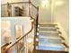 Carpeted staircase with wooden railings at 311 Carmichael Cir, Canton, GA 30115