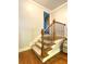 Staircase with carpet steps, wood trim and black metal rails at 311 Carmichael Cir, Canton, GA 30115