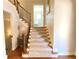Elegant staircase with carpeted steps and wooden handrails at 311 Carmichael Cir, Canton, GA 30115