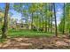 The home boasts a well-maintained backyard with lush green grass and mature trees at 4425 Reef Rd, Marietta, GA 30066