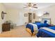 A well-lit bedroom with two beds, a ceiling fan, and cozy decor at 4425 Reef Rd, Marietta, GA 30066