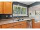 A double basin sink with wood cabinets and stainless steel dishwasher at 4425 Reef Rd, Marietta, GA 30066