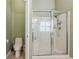 Bright bathroom featuring a shower with glass door and a toilet at 4510 Flowering Br, Powder Springs, GA 30127