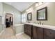 Bright bathroom featuring a double vanity, tub, and a door to the walk in closet at 4510 Flowering Br, Powder Springs, GA 30127