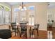 Dining room with natural light, chandelier, and wood table with black chairs at 4510 Flowering Br, Powder Springs, GA 30127