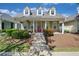Charming one-story home featuring a cozy porch with colorful front door and well-manicured front yard at 4510 Flowering Br, Powder Springs, GA 30127