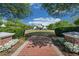 A charming home is showcased from the end of a brick walkway, framed by manicured greenery and a spacious front lawn at 4510 Flowering Br, Powder Springs, GA 30127