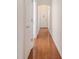 Bright hallway features gleaming hardwood floors and white trim throughout the space at 4510 Flowering Br, Powder Springs, GA 30127