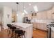 Modern kitchen featuring stainless steel appliances, a central island with seating, and bright skylights at 4510 Flowering Br, Powder Springs, GA 30127