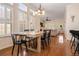 Bright open concept dining and living area with hardwood floors and lots of natural light at 4510 Flowering Br, Powder Springs, GA 30127