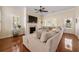 Spacious living room with a fireplace, large sectional sofa and lots of natural light at 4510 Flowering Br, Powder Springs, GA 30127