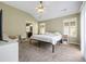 Bedroom features a large bed, vaulted ceilings, natural light from shuttered windows, and en suite bathroom at 4510 Flowering Br, Powder Springs, GA 30127