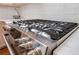 Close-up of a stainless steel gas cooktop and white tile backsplash at 4510 Flowering Br, Powder Springs, GA 30127