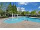 Relax in the community pool, complete with a pergola and lounge chairs, on a beautiful, sunny day at 4510 Flowering Br, Powder Springs, GA 30127