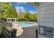 View of the sparkling community pool with ample seating and beautiful landscaping on a bright, sunny day at 4510 Flowering Br, Powder Springs, GA 30127