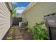 Well-maintained side yard with lush greenery, brick pathway, and AC unit for a tranquil outdoor space at 4510 Flowering Br, Powder Springs, GA 30127