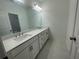 Bathroom features a long double vanity, decorative tile, and modern fixtures at 5022 Buice Crest Court, Buford, GA 30518