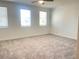Large bedroom featuring neutral carpet, three windows providing plenty of natural light, and ample space at 5022 Buice Crest Court, Buford, GA 30518