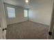 Bright bedroom featuring two windows and neutral carpet flooring at 5022 Buice Crest Court, Buford, GA 30518