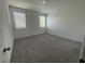 Bright bedroom featuring two windows and neutral carpet flooring at 5022 Buice Crest Court, Buford, GA 30518