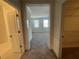 View of a bedroom through a hallway with carpet flooring and natural light at 5022 Buice Crest Court, Buford, GA 30518