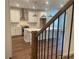 Bright, modern kitchen featuring an island, stainless hood, and hardwood flooring at 5022 Buice Crest Court, Buford, GA 30518