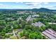 Aerial view showcasing the neighborhood with lush greenery and homes below at 800 Kiowa Ne Dr, Marietta, GA 30060