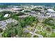 Expansive aerial view of a residential area, showcasing tree coverage and nearby commercial buildings at 800 Kiowa Ne Dr, Marietta, GA 30060