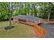 Aerial view of a brick home showcasing the large backyard and driveway at 800 Kiowa Ne Dr, Marietta, GA 30060
