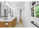 Bathroom featuring double sinks, quartz counters and lots of natural light at 800 Kiowa Ne Dr, Marietta, GA 30060