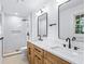 Renovated bathroom featuring double sinks, modern vanities and mirrors, with a walk-in shower at 800 Kiowa Ne Dr, Marietta, GA 30060