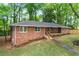An eye-level exterior view showing the brick facade and tidy lawn of this inviting single story home at 800 Kiowa Ne Dr, Marietta, GA 30060