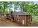 Brick home featuring a back deck, neutral trim, a chimney, an exterior door, and a manicured lawn at 800 Kiowa Ne Dr, Marietta, GA 30060