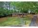 Quaint brick home with well-kept lawn, mature trees, and a charming front porch at 800 Kiowa Ne Dr, Marietta, GA 30060