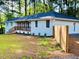 Stylish white brick home with a dark roof, a cozy front porch and neatly landscaped front yard at 800 Kiowa Ne Dr, Marietta, GA 30060