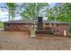 Exterior of beautiful brick home with a wooden deck in a leafy and verdant setting at 800 Kiowa Ne Dr, Marietta, GA 30060