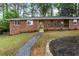 A welcoming brick home with a cozy front porch and meticulously maintained landscaping at 800 Kiowa Ne Dr, Marietta, GA 30060