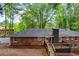 A high angle exterior shot of the back of the house, with a deck and brick chimney at 800 Kiowa Ne Dr, Marietta, GA 30060