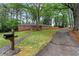 Lovely brick house with mature trees, a well-kept lawn, and a convenient mailbox at the end of the driveway at 800 Kiowa Ne Dr, Marietta, GA 30060