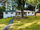 Charming white brick home featuring a welcoming front porch and meticulously landscaped yard at 800 Kiowa Ne Dr, Marietta, GA 30060