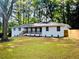 Charming single-story home featuring a covered porch and lush front lawn at 800 Kiowa Ne Dr, Marietta, GA 30060