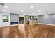 Bright open-concept living area flows into a kitchen, featuring hardwood floors and a modern fireplace at 800 Kiowa Ne Dr, Marietta, GA 30060