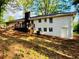 Home's rear view featuring a classic brick exterior, with a wooden deck and a well-maintained backyard at 800 Kiowa Ne Dr, Marietta, GA 30060