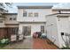 Private backyard patio with sliding glass doors and a small storage shed at 10900 Wittenridge Dr # I4, Alpharetta, GA 30022